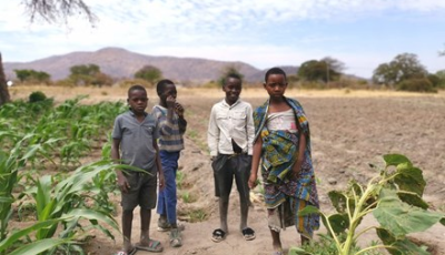 Four kids standing in a field