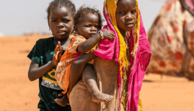 A girl carrying a baby in her back