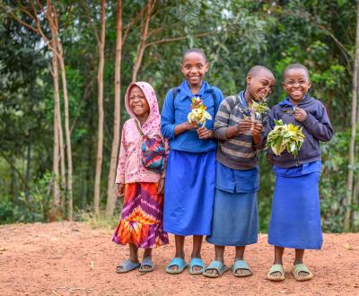 Four Girl Childrens with flowers and leaves in their hand.