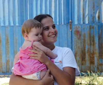 World Vision representative holding a toddler from Albania