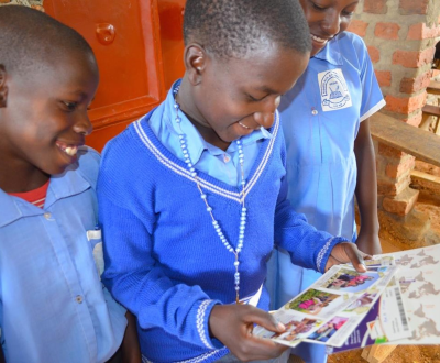 World Vison's sponsored child Kasonga from Uganda shows his friends the cards he got from his sponsor