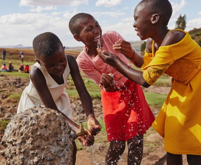 Kids playing in water from the tap