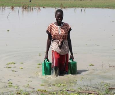  Ator collects buckets of water to irrigate her village's farm