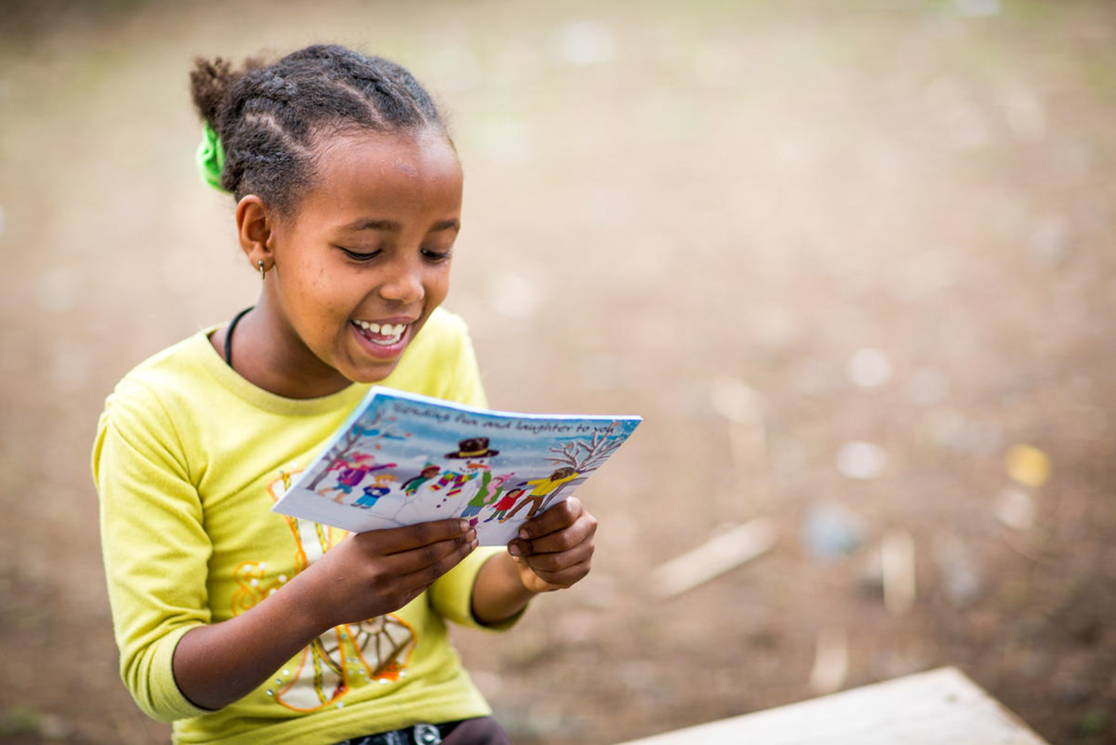 World Vision's sponsored child, Helen, from Ethiopia reading her sponsor's card