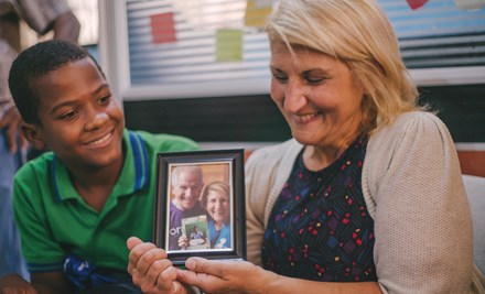 Boy meets his sponsor in the Dominican Republic, and she holds the picture of herself and her husband