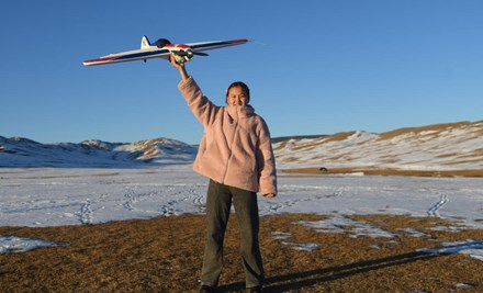 16 years old sponsored child Nomin from Mongolia holding Model Aircraft.