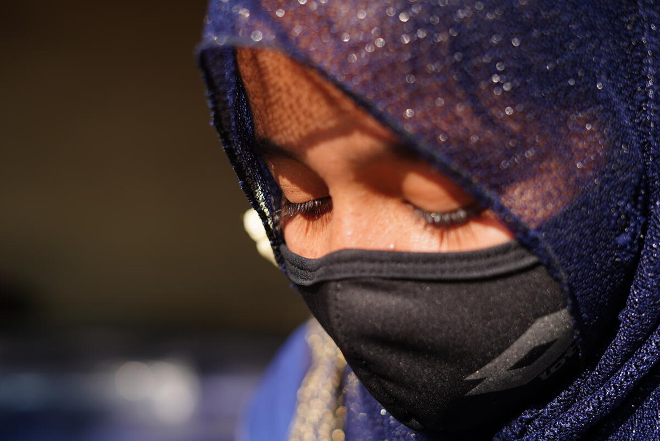 Close-up picture of girl from Bangladesh wearing a headscarf and a facemask