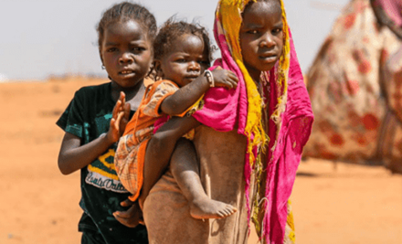 A girl carrying a baby in her back