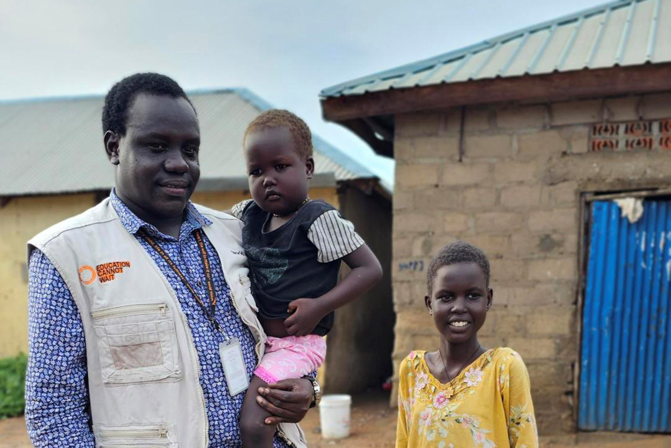 World vision staff carrying a child